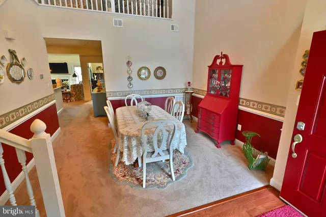 a view of a dining room with furniture wooden floor and windows