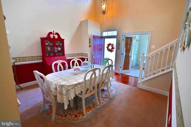 a view of livingroom and dining room with furniture wooden floor and windows