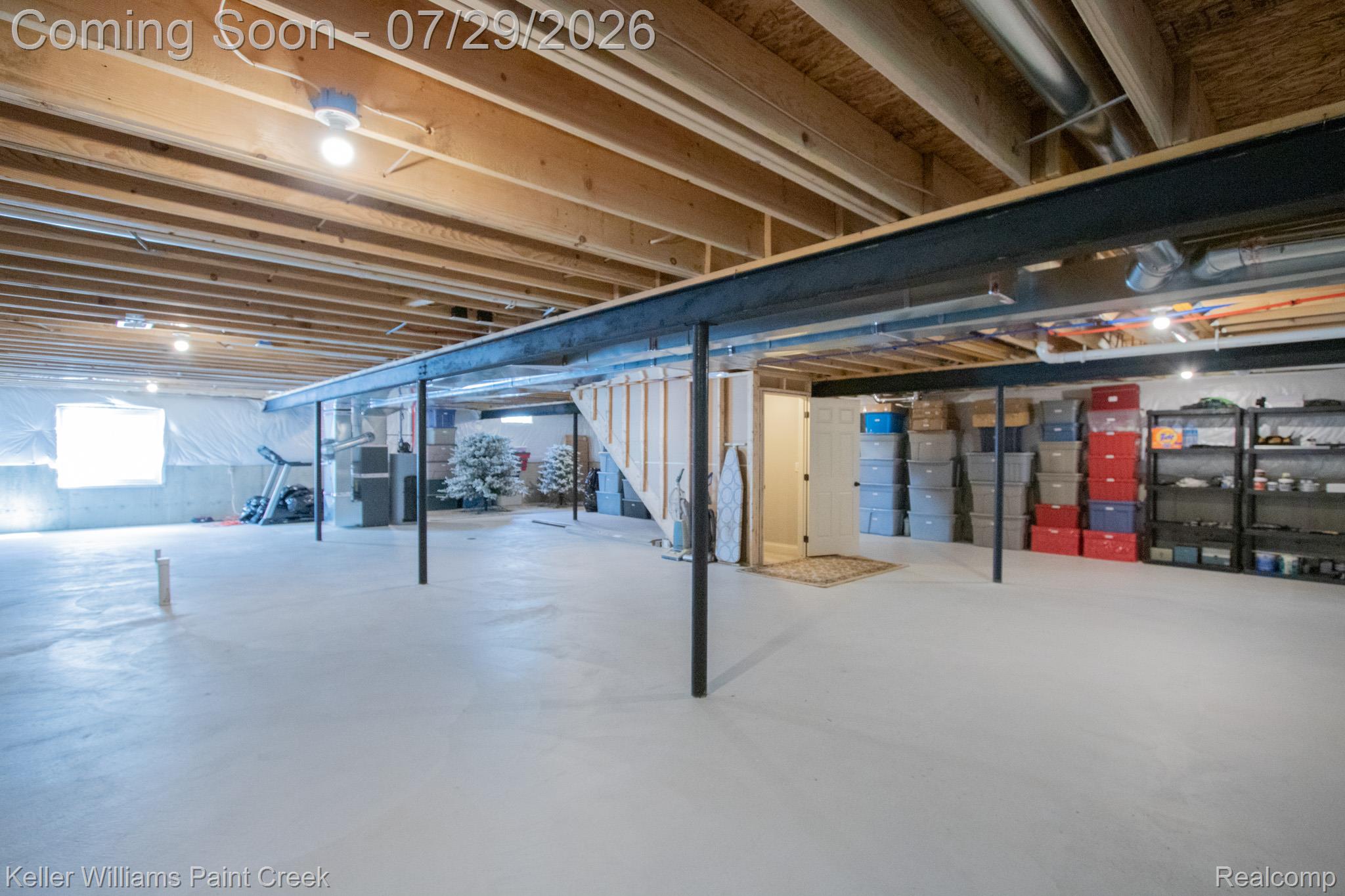 49118 Ridgeview Drive Macomb, MI 48044 - Photo 39 of 57 Unfinished basement offering expansive open space, exposed wood joists, a white painted concrete floor, and a single window providing natural light
