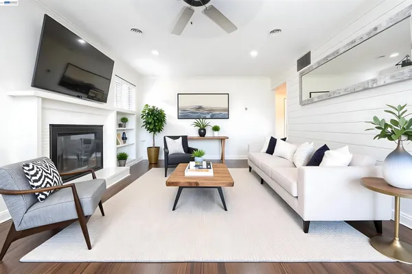 a living room with furniture a fireplace and a flat screen tv