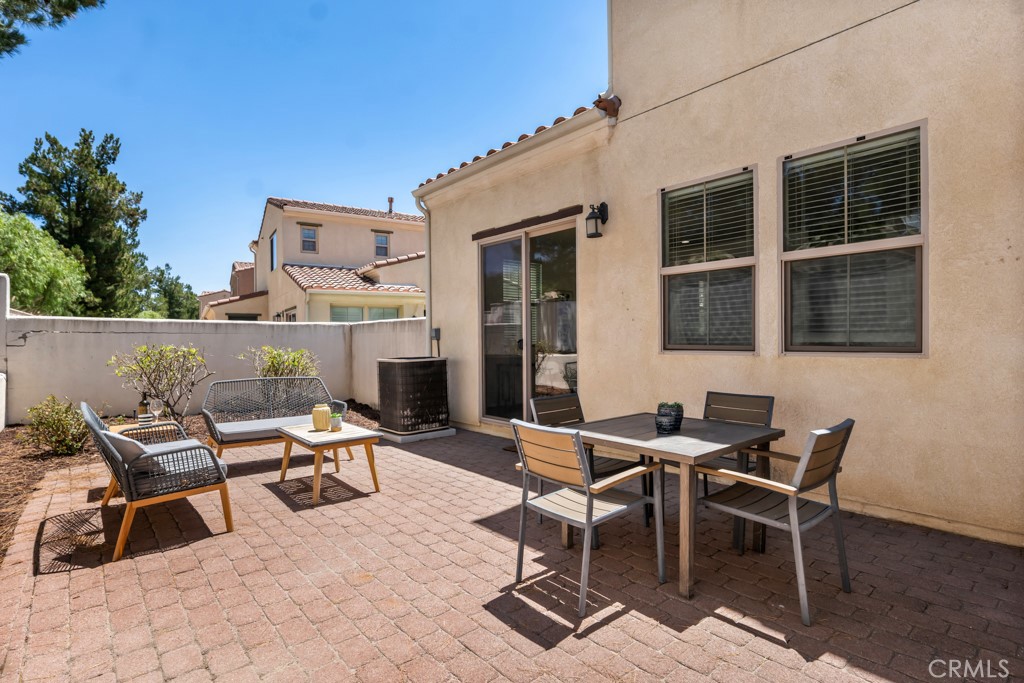 20317 Livorno Porter Ranch Porter Ranch, CA 91326 - Photo 26 of 33 a view of a patio with a dining table and chairs with wooden floor