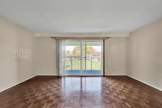 1114 Springinsguth Road, Unit 2A Schaumburg, IL 60193 - Photo 3 of 19 wooden floor in an empty room with a window