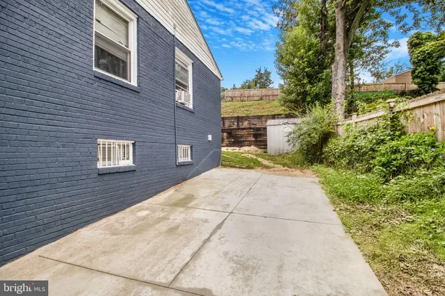 a view of a brick house with a yard