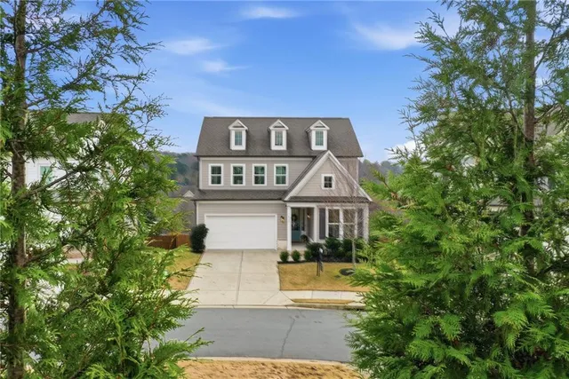 a front view of a house with a yard garage and outdoor seating