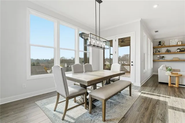 a view of front door with dining room and wooden floor