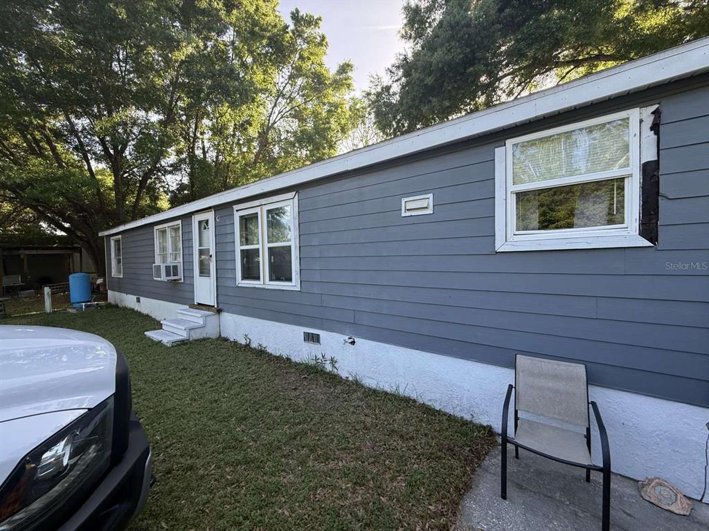 7098 North Golden Point Hernando, FL 34442 - Photo 3 of 11 a view of a backyard with couches plants and large trees