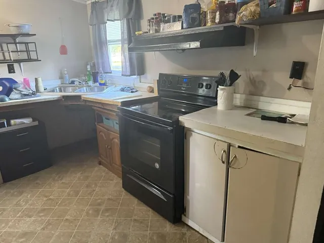 a kitchen with a sink and cabinets