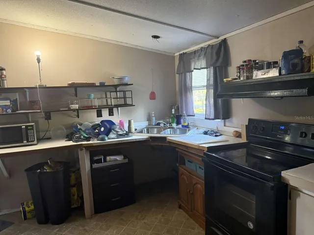 a kitchen with a sink and cabinets