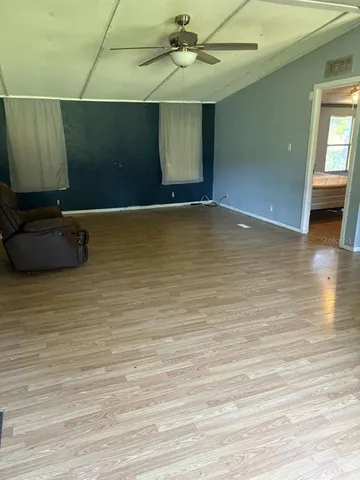 a view of a room with wooden floor