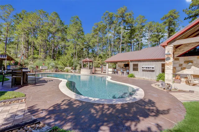 a swimming pool with outdoor seating and yard