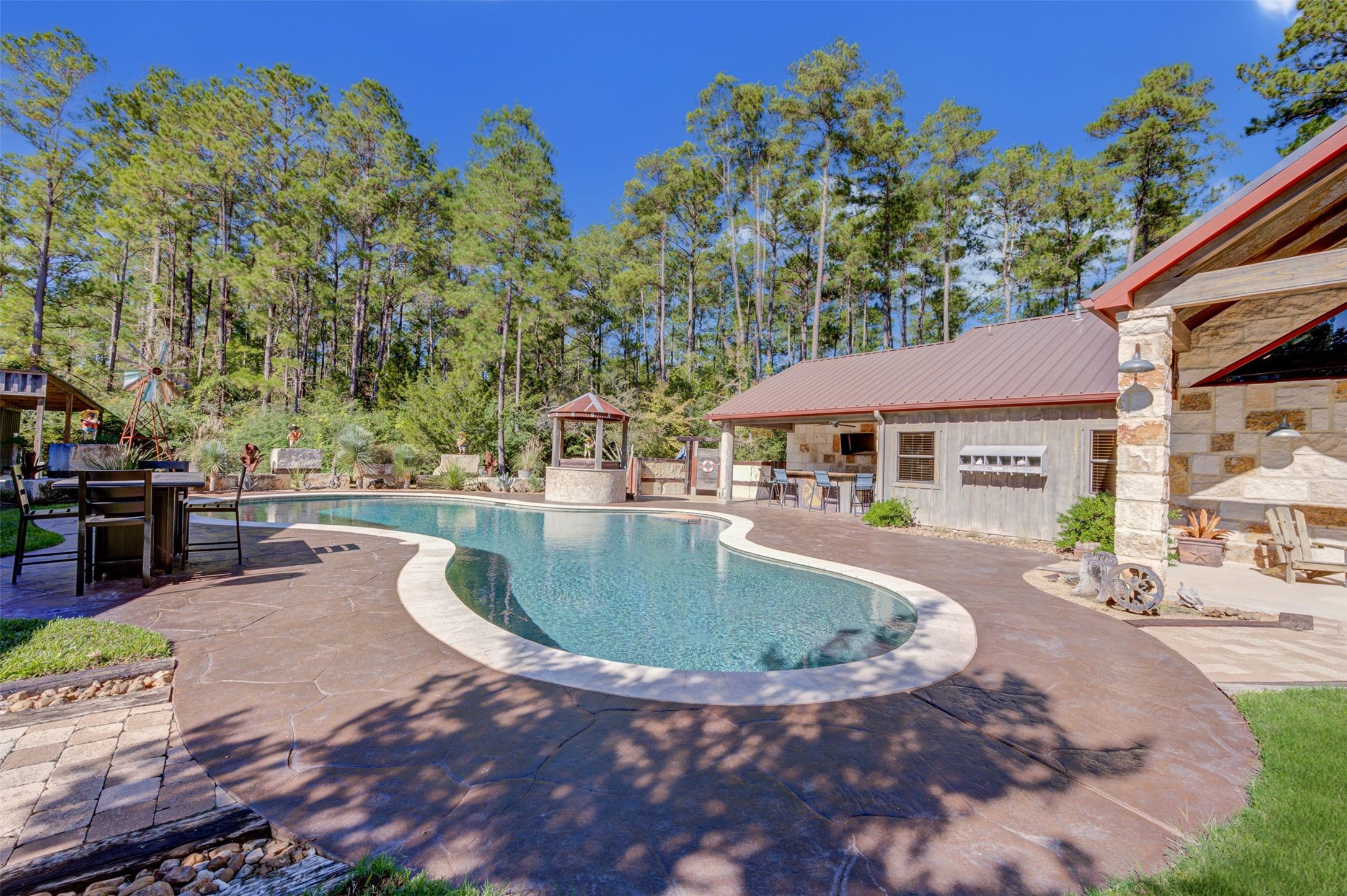 a swimming pool with outdoor seating and yard