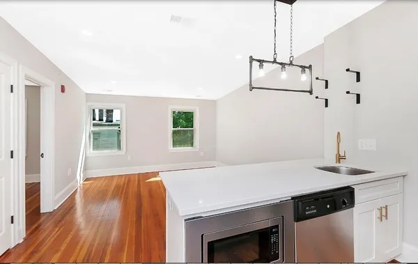 a kitchen with a sink a stove and a refrigerator