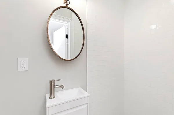 a close up of a mirror and a sink