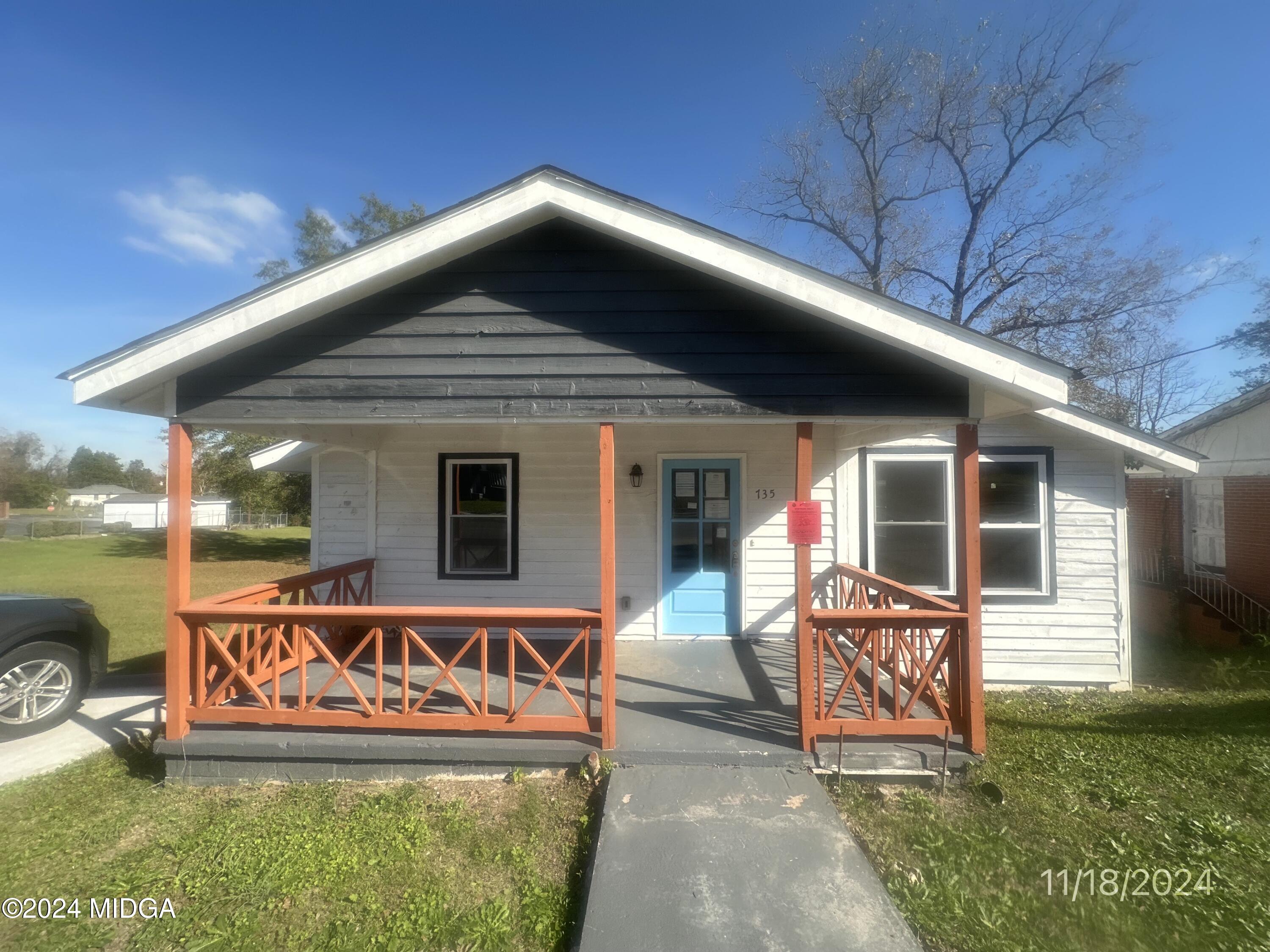 a front view of a house with garden