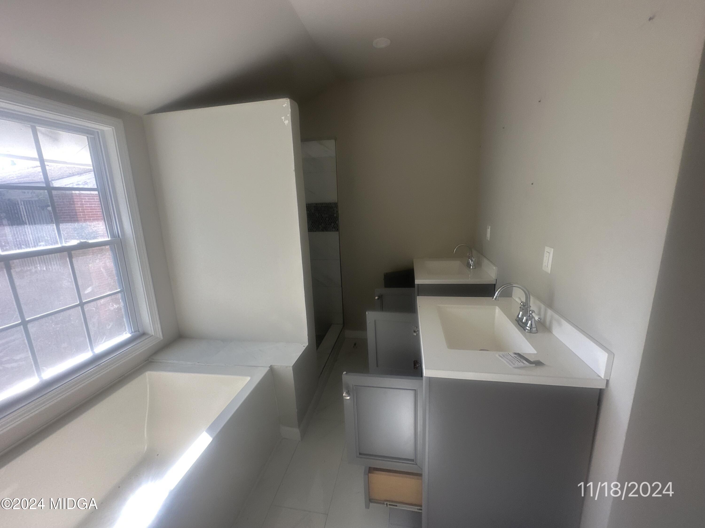 735 Maynard Street Macon, GA 31217 - Photo 7 of 9 a bathroom with a sink a bathtub and window