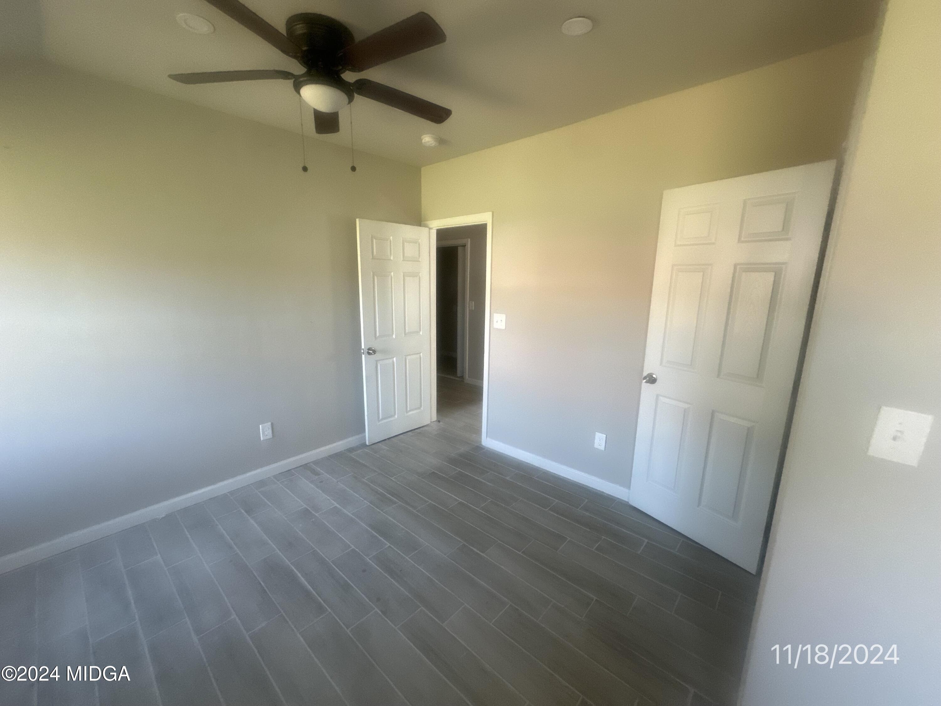 735 Maynard Street Macon, GA 31217 - Photo 8 of 9 en empty room with wooden floor and a ceiling fan