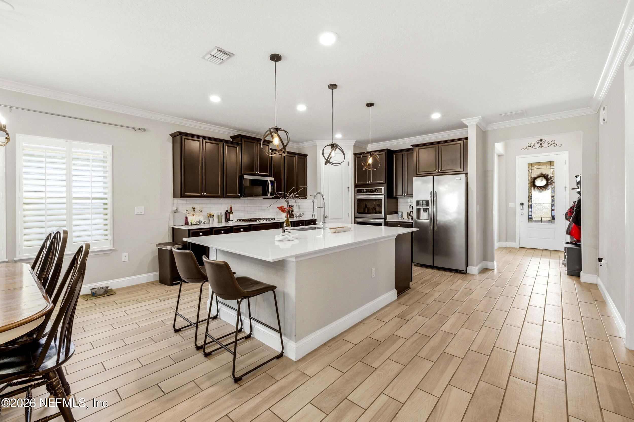 113 Howell Court St. Augustine, FL 32092 - Photo 25 of 63 a large kitchen with a table chairs refrigerator and microwave