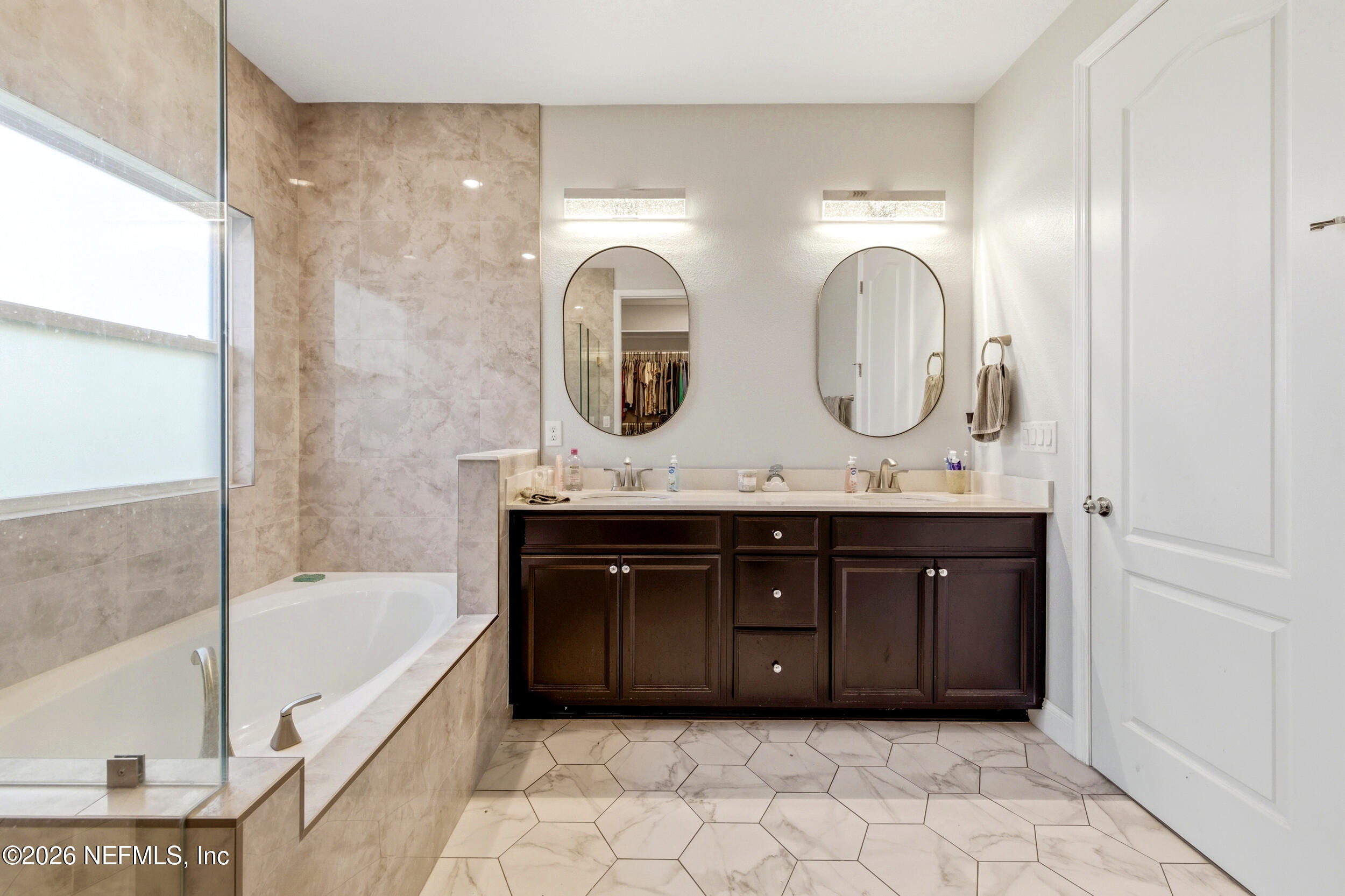 113 Howell Court St. Augustine, FL 32092 - Photo 38 of 63 a bathroom with a double vanity sink mirror and bathtub