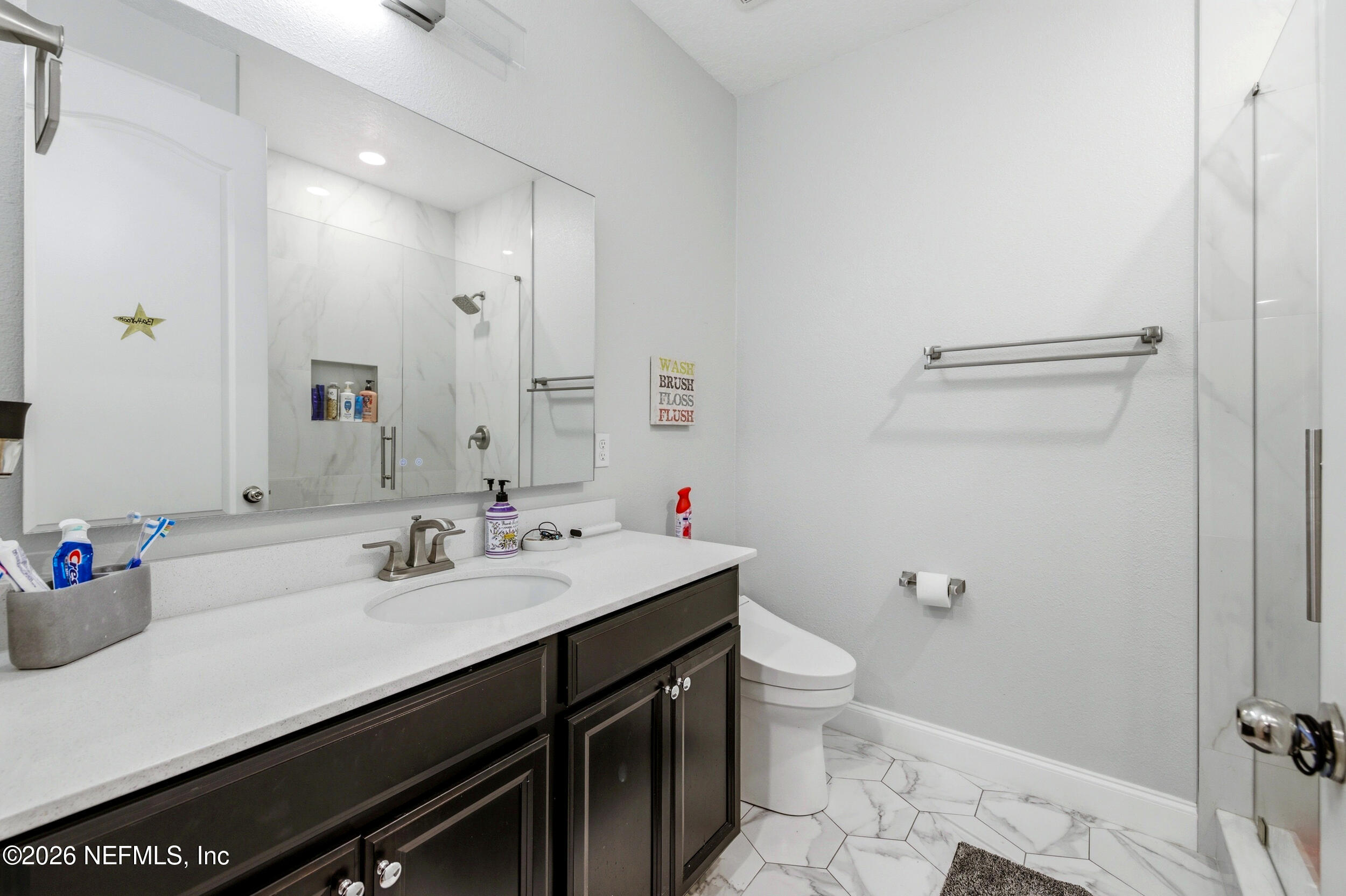 113 Howell Court St. Augustine, FL 32092 - Photo 40 of 63 a bathroom with a sink a toilet a shower and a mirror