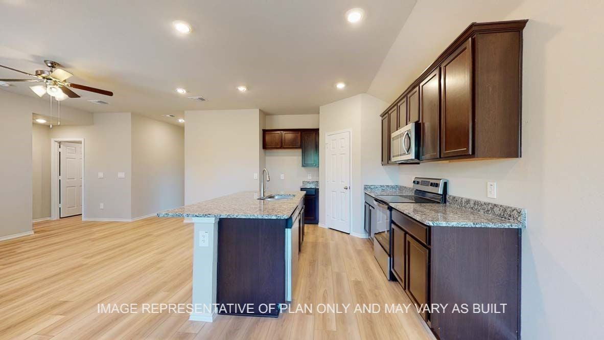 2805 Cyprian Road Lorena, TX 76655 - Photo 5 of 21 a kitchen with stainless steel appliances granite countertop a sink a stove and a refrigerator