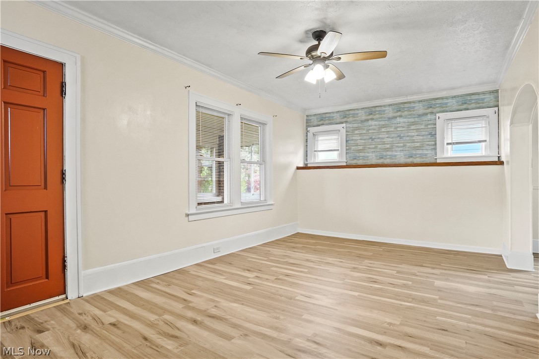 688 Ranney Street Akron, OH 44310 - Photo 12 of 35 Empty room with ornamental molding, light hardwood / wood-style floors, and ceiling fan