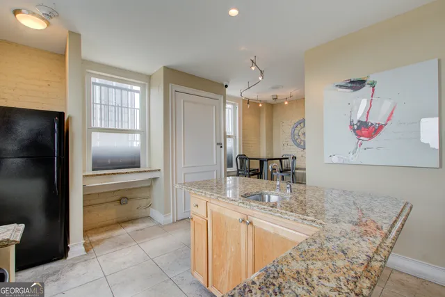 a kitchen with a refrigerator and a sink