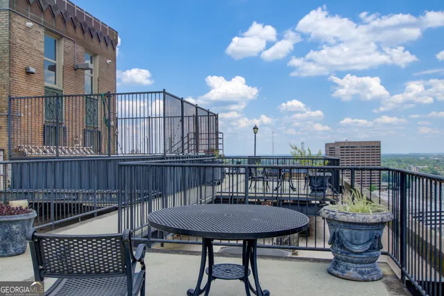 a balcony with table and chairs