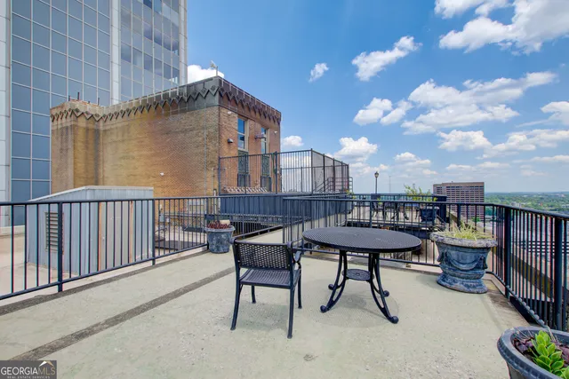 a view of a chair and tables in the terrace