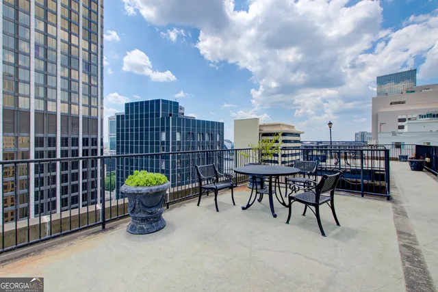 a building outdoor space with patio furniture and a potted plant