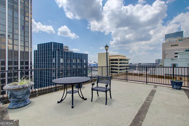a view of a roof deck with furniture
