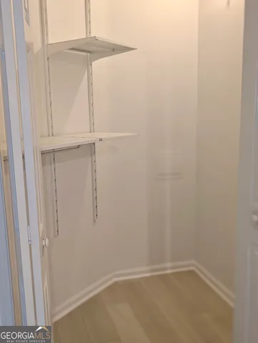 a view of an empty room with chandelier