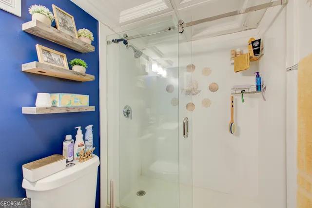 a view of a workspace with furniture and a flat screen tv