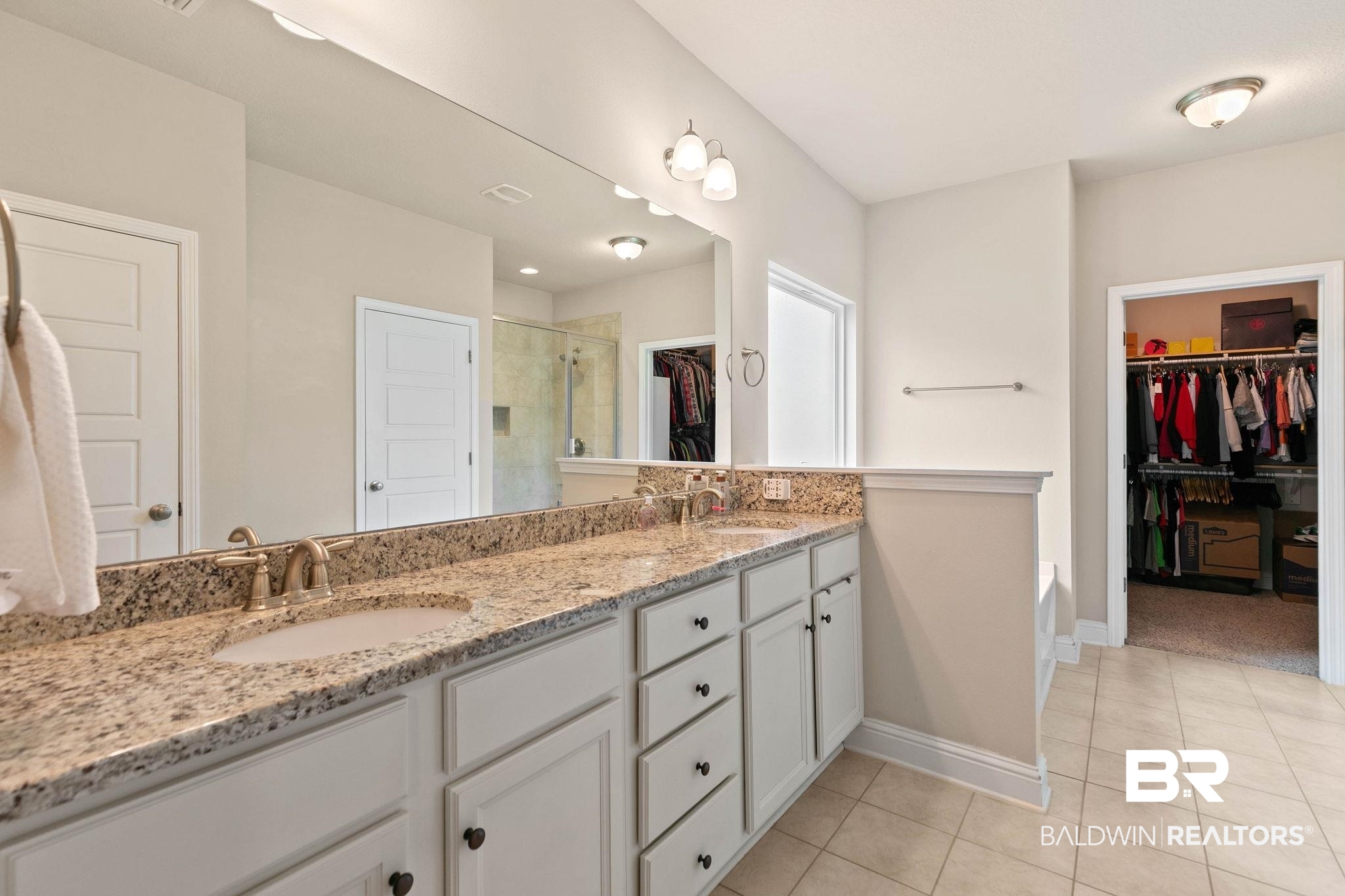 12750 B Jenkins Pit Road Daphne, AL 36527 - Photo 34 of 89 Bathroom featuring a spacious closet, a stall shower, double vanity, and light tile patterned floors