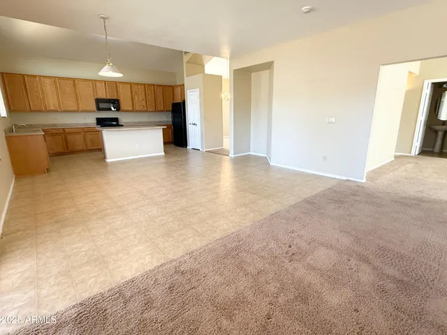 a view of living room kitchen with furniture and wooden floor