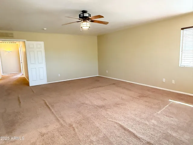 a view of room with a ceiling fan and window