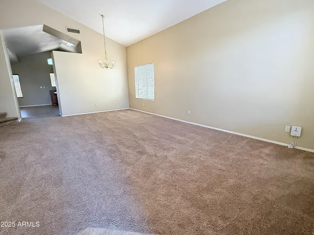 an empty room with a window and a ceiling fan