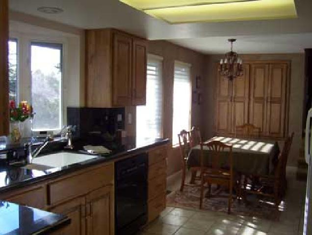 10107 Zier Road Yakima, WA 98908 - Photo 4 of 7 a kitchen with granite countertop a stove a sink dishwasher and a microwave oven