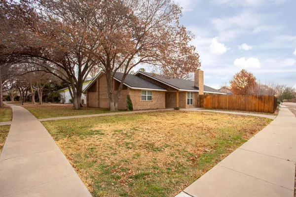 a backyard of house with large trees