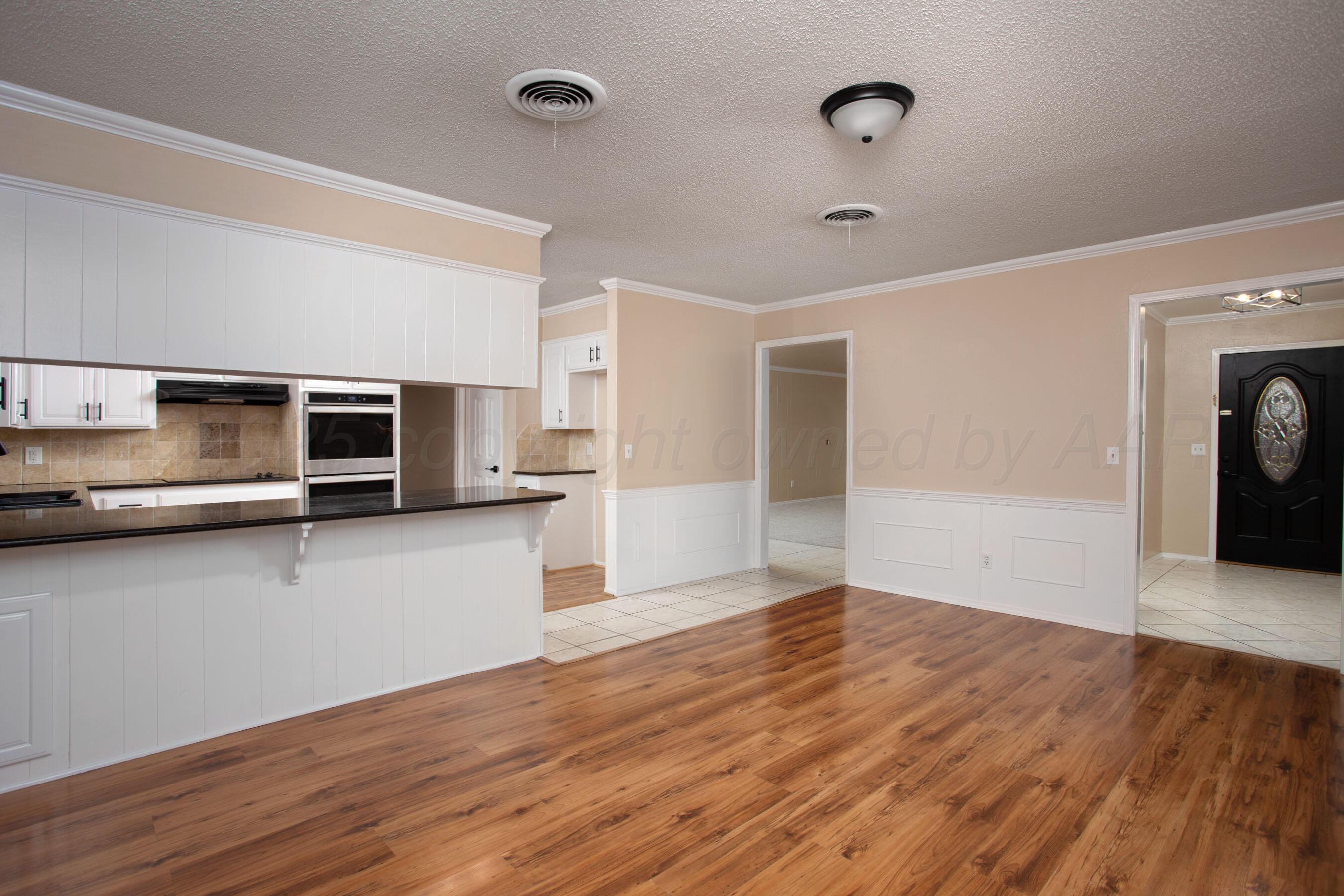 3529 Cinderella Lane Amarillo, TX 79121 - Photo 12 of 33 a view of a kitchen with wooden floor and electronic appliances