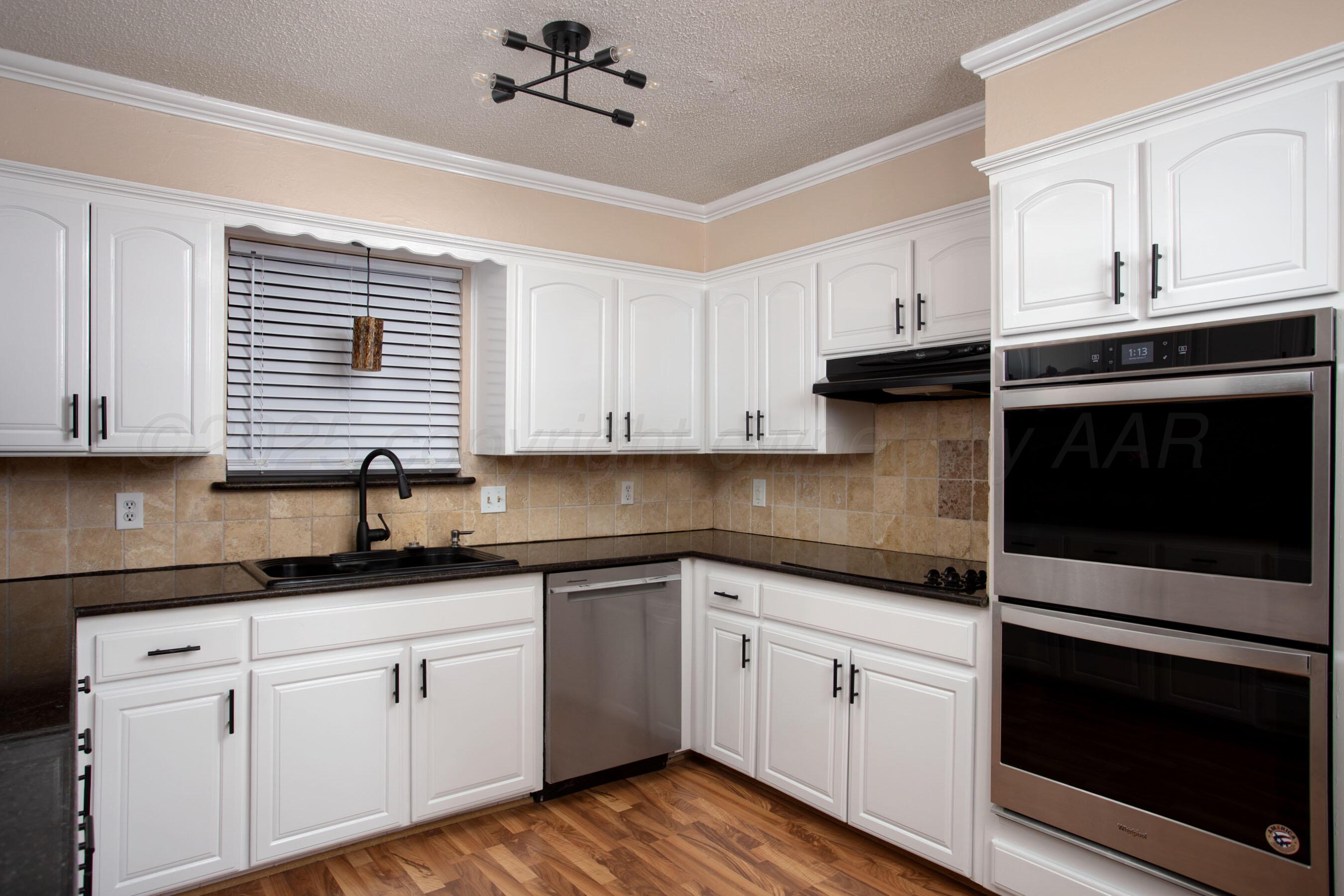 3529 Cinderella Lane Amarillo, TX 79121 - Photo 13 of 33 a kitchen with granite countertop cabinets stainless steel appliances and a sink