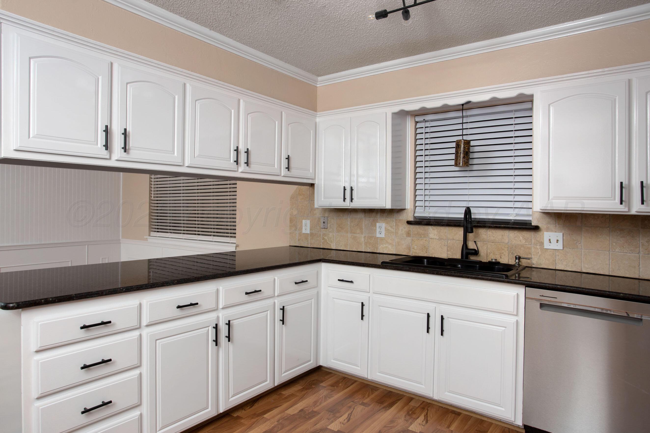 3529 Cinderella Lane Amarillo, TX 79121 - Photo 14 of 33 a kitchen with granite countertop white cabinets and white appliances
