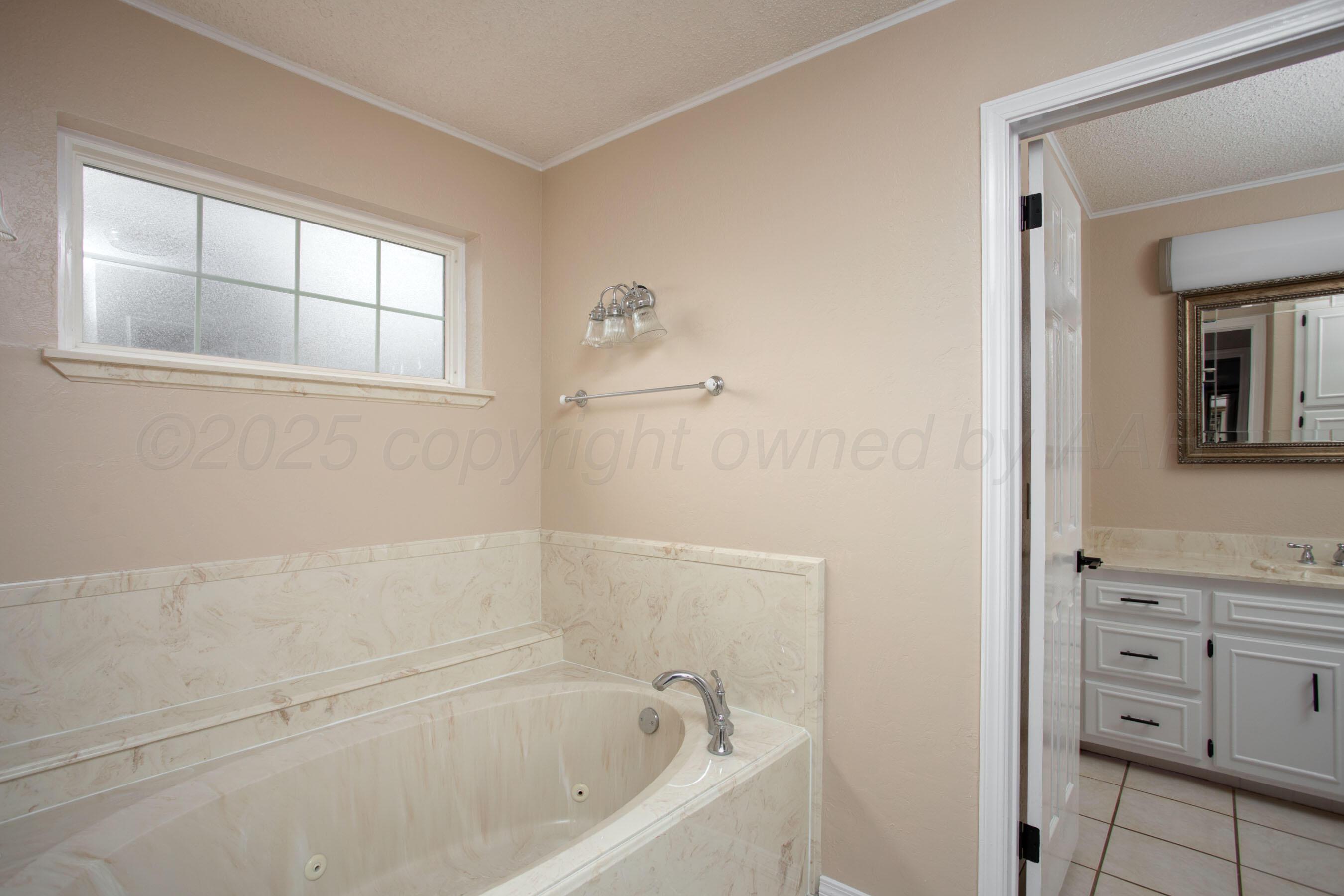 3529 Cinderella Lane Amarillo, TX 79121 - Photo 20 of 33 a bathroom with bathtub and window