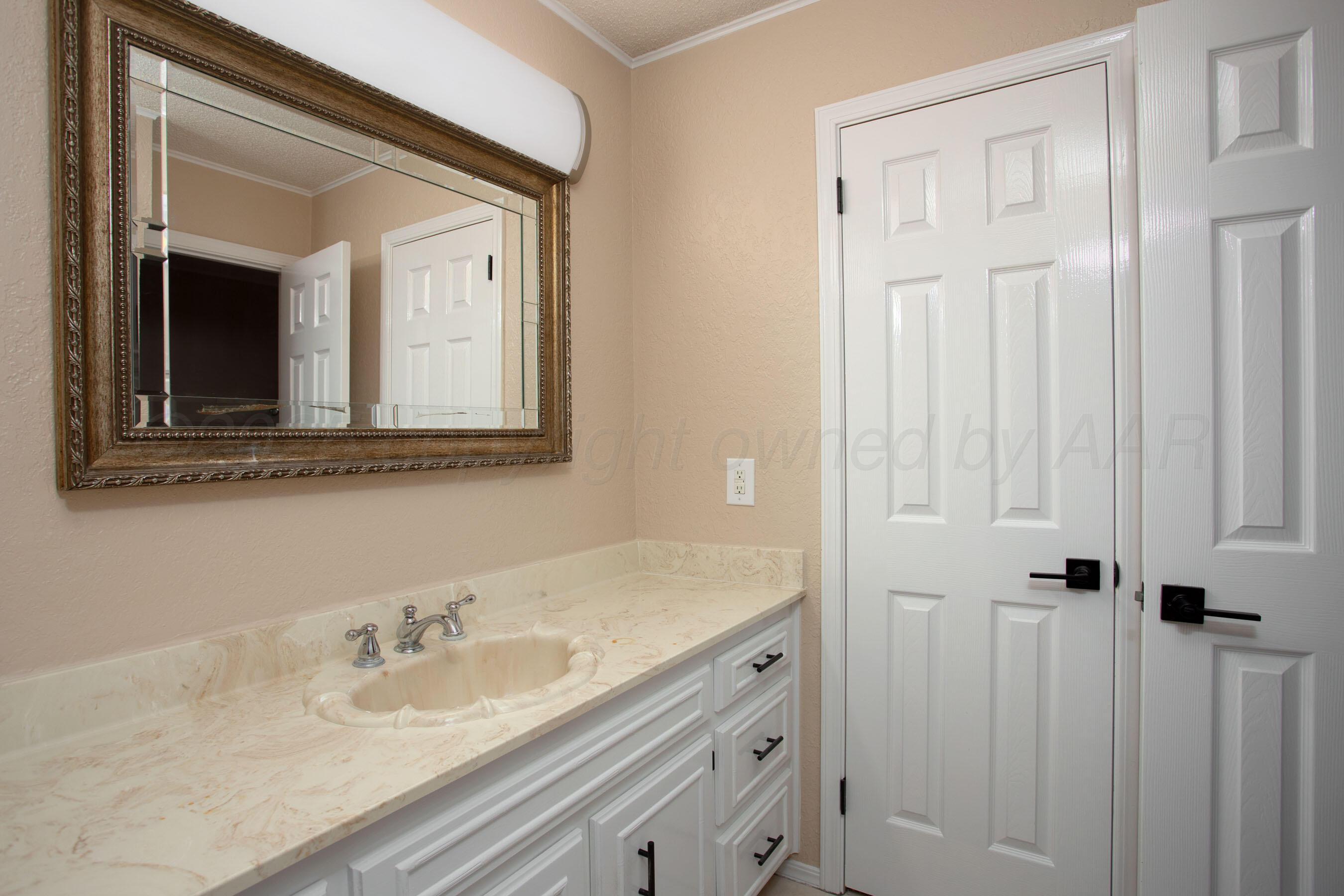 3529 Cinderella Lane Amarillo, TX 79121 - Photo 22 of 33 a bathroom with a sink and a mirror