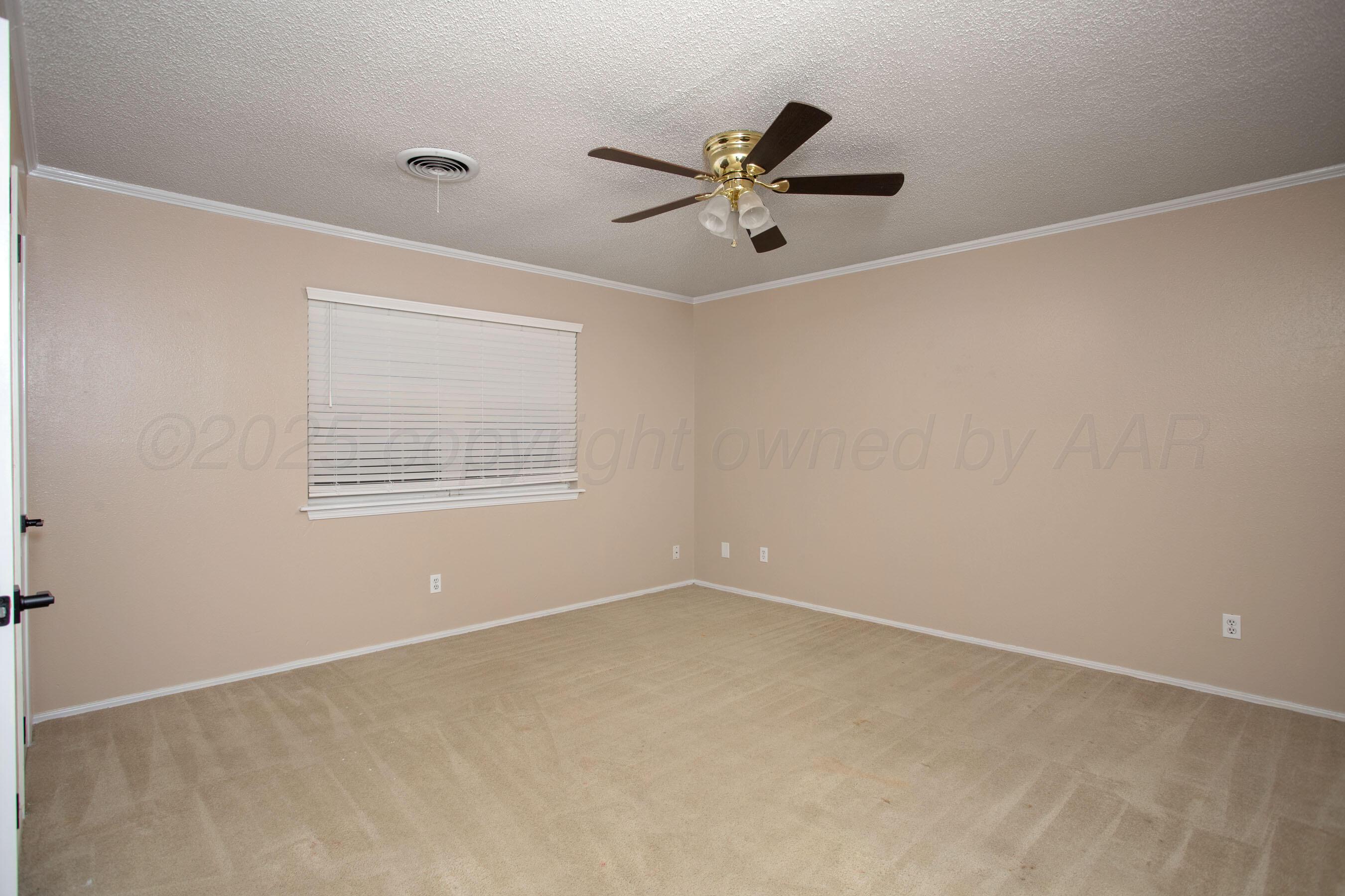3529 Cinderella Lane Amarillo, TX 79121 - Photo 23 of 33 an empty room with a window and a fan