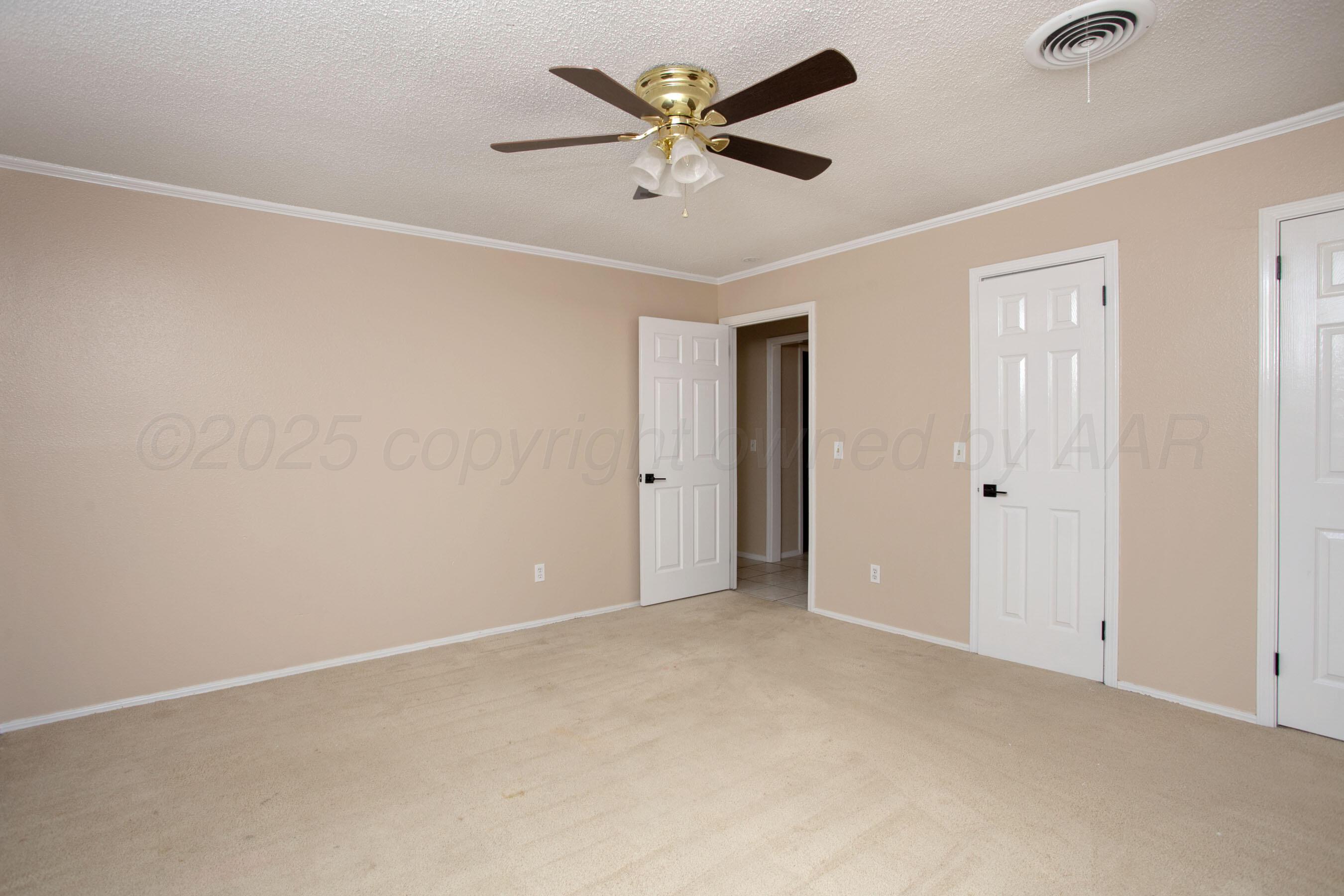 3529 Cinderella Lane Amarillo, TX 79121 - Photo 24 of 33 an empty room with closet and a ceiling fan