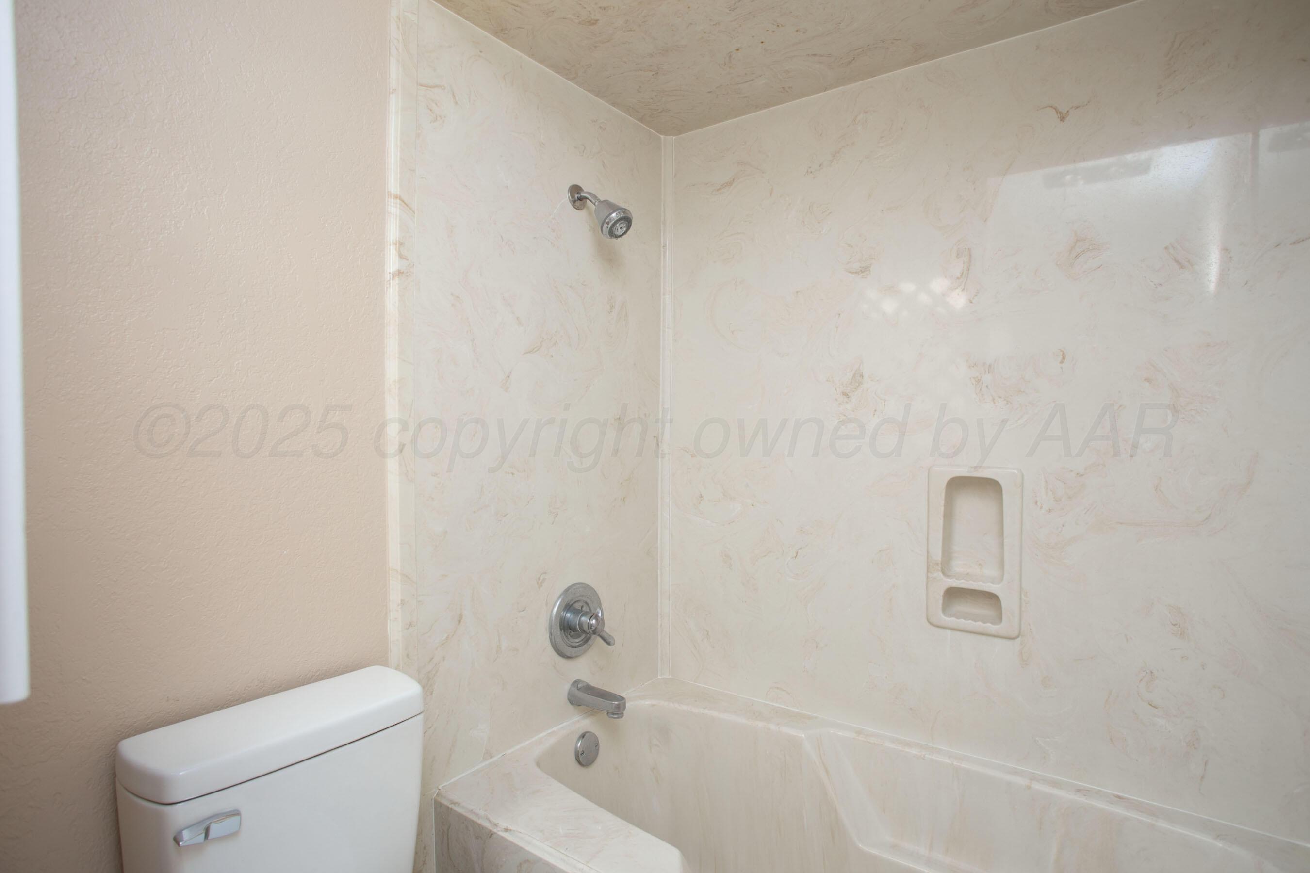 3529 Cinderella Lane Amarillo, TX 79121 - Photo 28 of 33 a bathroom with a toilet and a tub