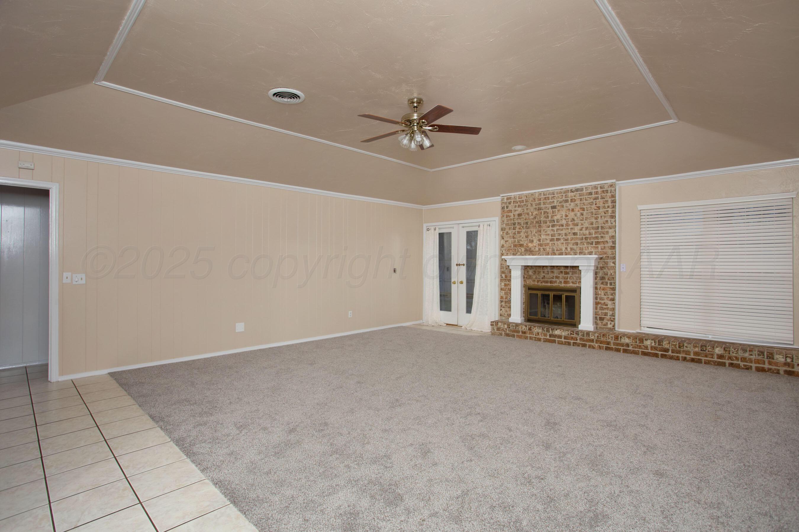 3529 Cinderella Lane Amarillo, TX 79121 - Photo 6 of 33 an empty room with windows and fireplace