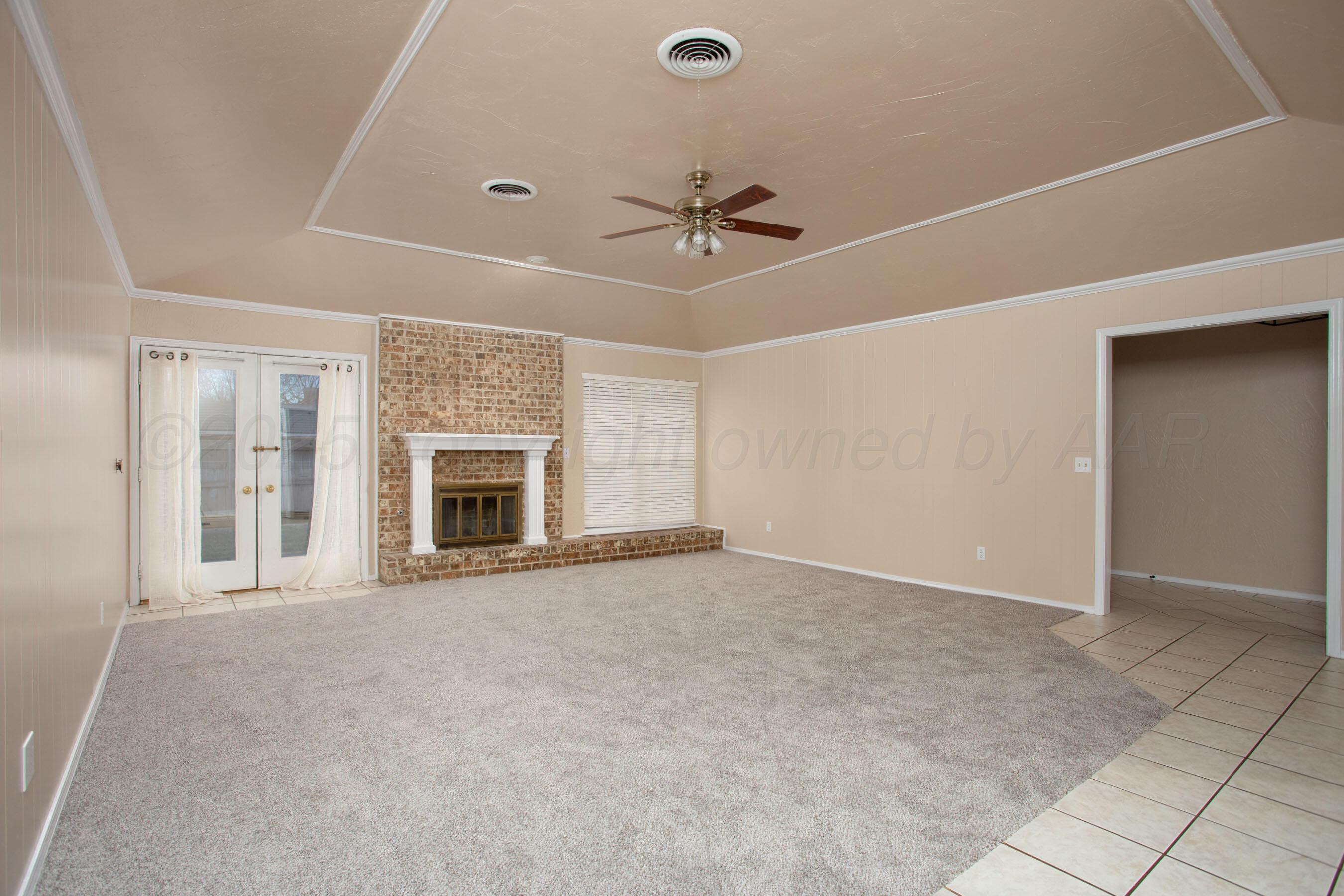 3529 Cinderella Lane Amarillo, TX 79121 - Photo 7 of 33 a view of an empty room with a fireplace and a window
