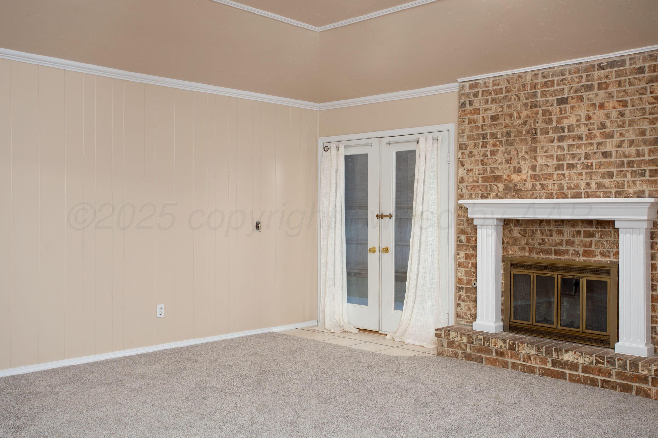3529 Cinderella Lane Amarillo, TX 79121 - Photo 8 of 33 an empty room with a fireplace