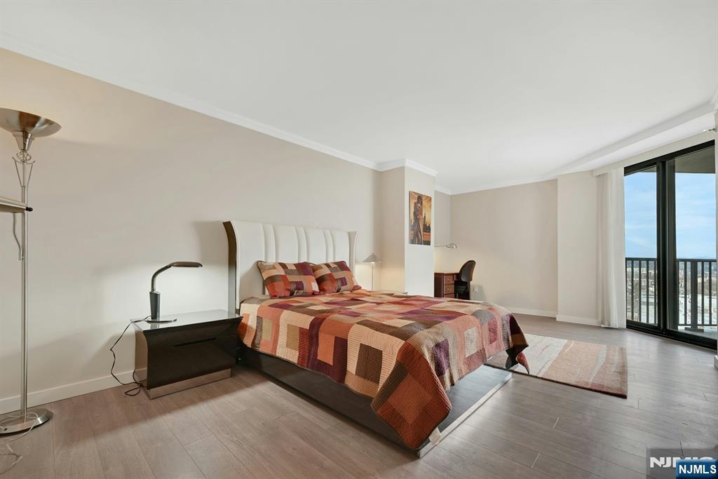 245 Prospect Avenue, Unit 12B Hackensack, NJ 07601 - Photo 15 of 33 a bedroom with a bed and a window